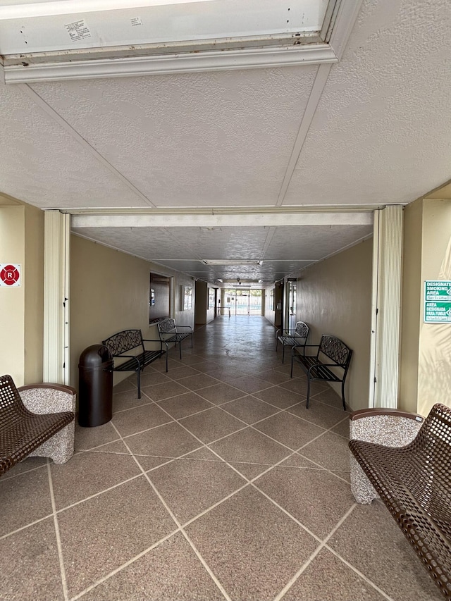 corridor featuring a textured ceiling