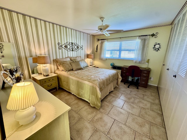 bedroom featuring ceiling fan, a closet, and light tile patterned floors