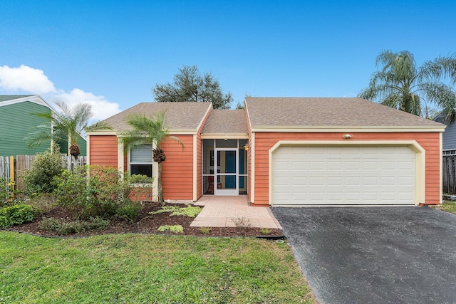 single story home with a garage and a front lawn