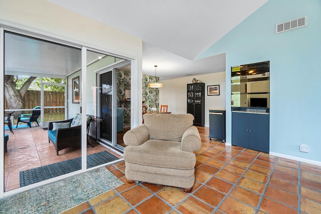 living room featuring lofted ceiling and dark tile patterned flooring