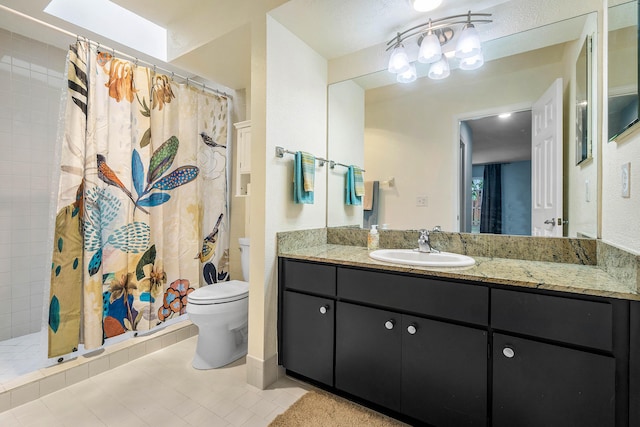 bathroom featuring curtained shower, tile patterned flooring, vanity, and toilet