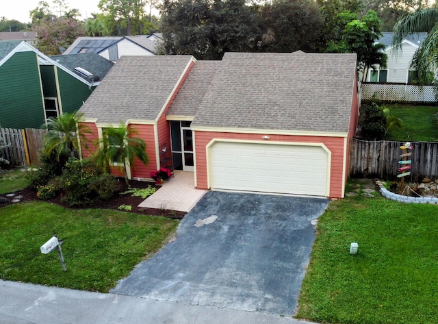 view of front of property featuring a front yard and a garage