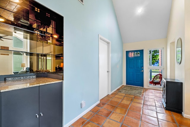 tiled foyer with high vaulted ceiling and ceiling fan