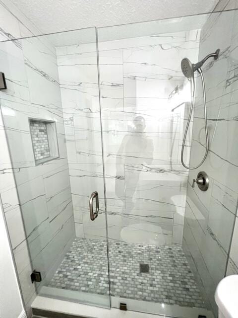 bathroom with an enclosed shower and toilet