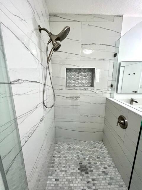 bathroom with a tile shower