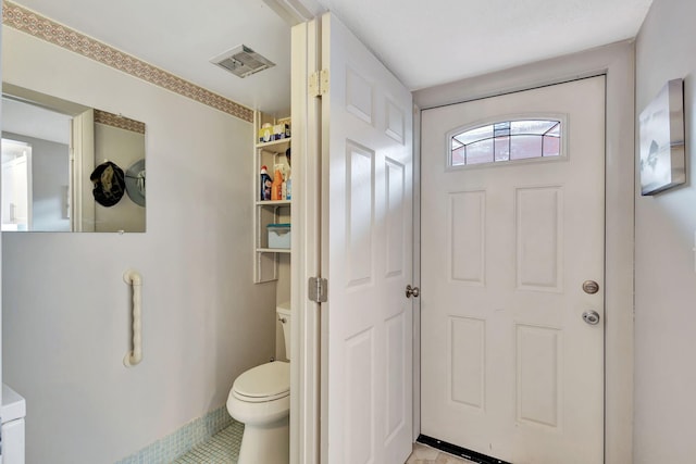 bathroom with tile patterned flooring and toilet