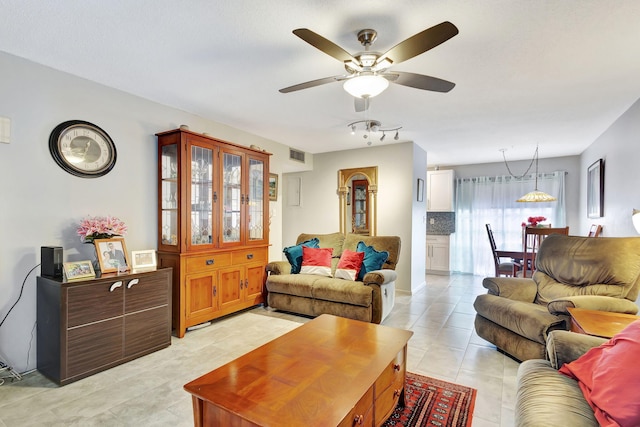 tiled living room featuring ceiling fan