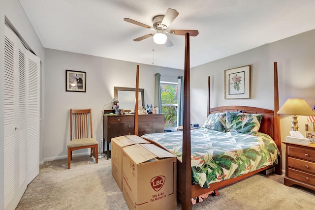 carpeted bedroom featuring ceiling fan and a closet