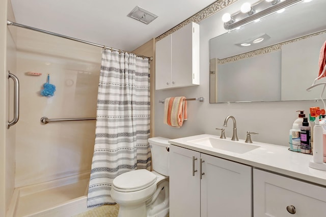 bathroom featuring vanity, toilet, and walk in shower