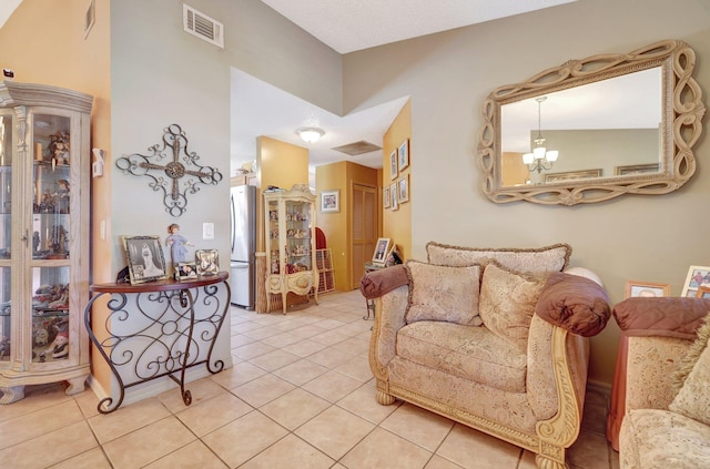 living room with light tile patterned floors and a chandelier