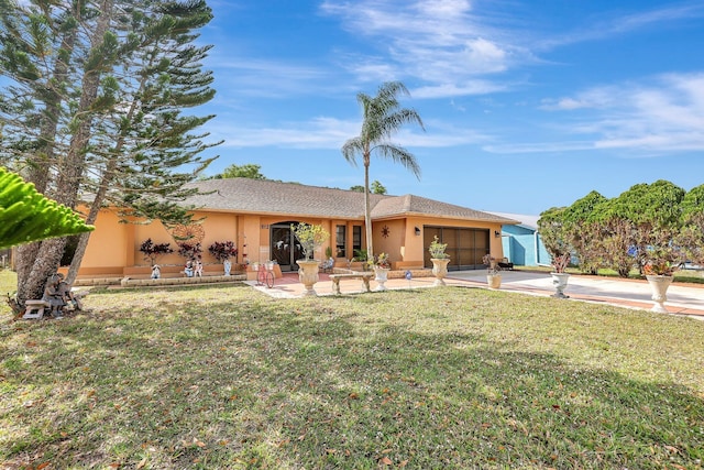 back of property featuring a garage and a yard