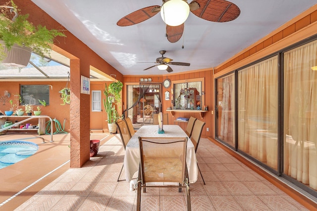 dining room featuring wood walls