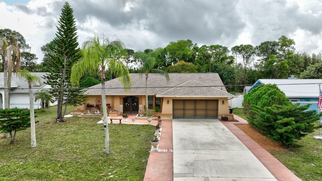 single story home featuring a garage and a front yard