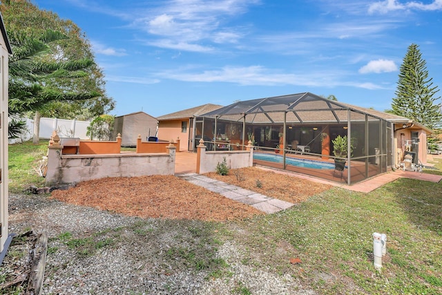 view of yard with a swimming pool with hot tub, a lanai, and a patio area