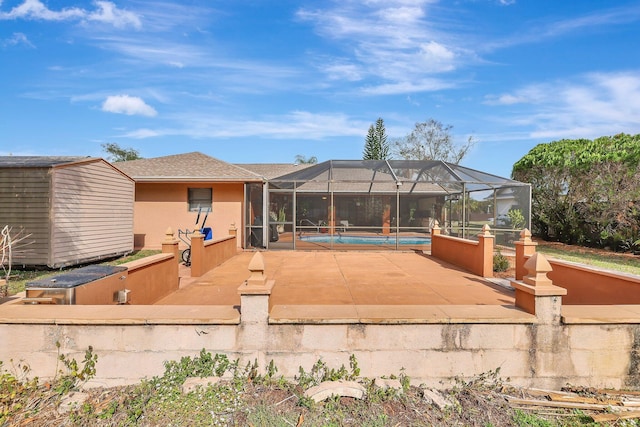 back of property with a lanai and a patio area