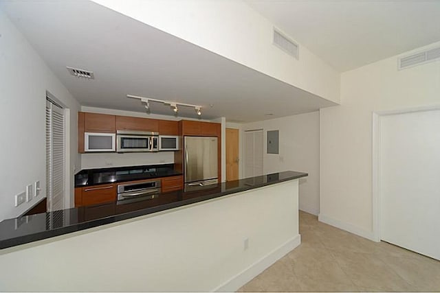 kitchen featuring light tile patterned floors, electric panel, and stainless steel appliances