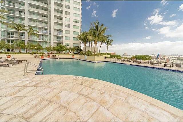 view of swimming pool with a patio area