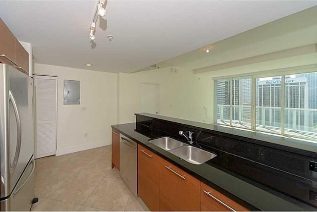 kitchen featuring appliances with stainless steel finishes, track lighting, sink, electric panel, and light tile patterned flooring