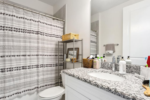 bathroom featuring toilet and vanity