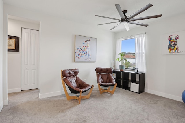 sitting room featuring ceiling fan and light colored carpet