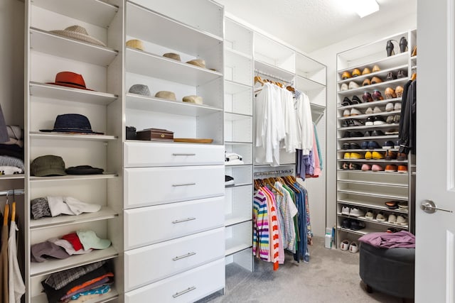 walk in closet featuring carpet