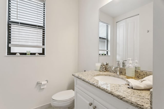 bathroom featuring toilet and vanity