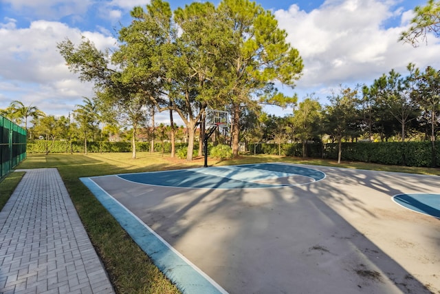 view of sport court with a yard