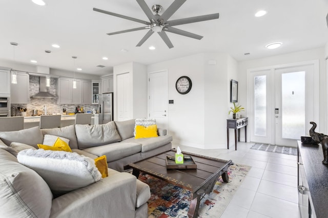 living room with ceiling fan, light tile patterned floors, and french doors