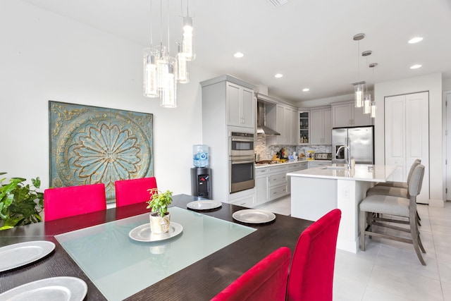 dining area with sink and light tile patterned floors