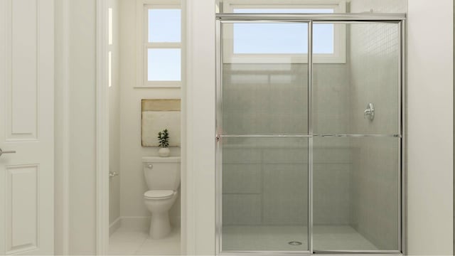 bathroom with tile patterned flooring, toilet, and a shower with door