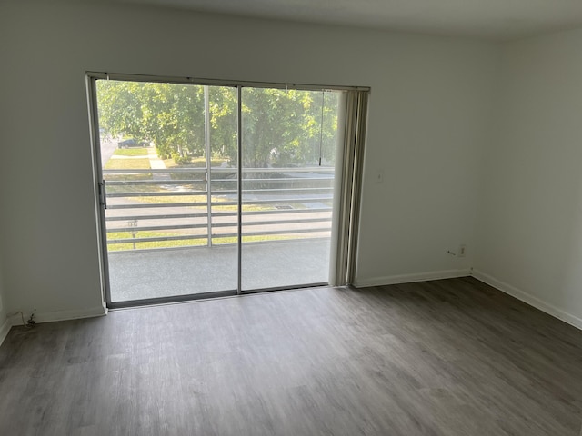 unfurnished room with hardwood / wood-style floors and a wealth of natural light