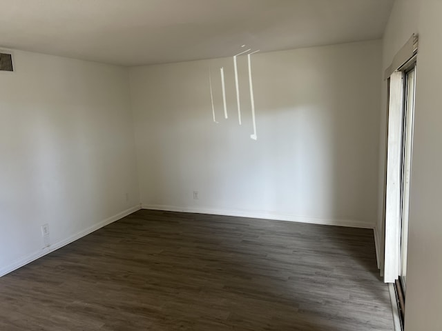 empty room featuring dark wood-type flooring