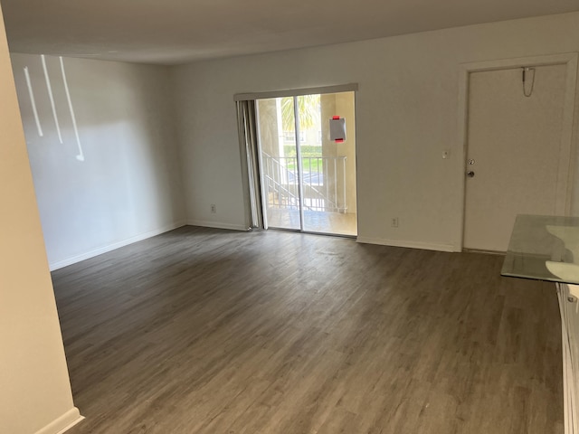 unfurnished living room with dark wood-type flooring