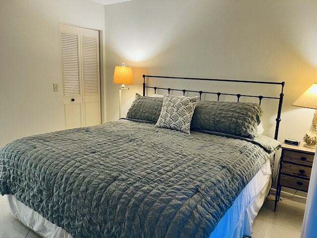 tiled bedroom featuring a closet