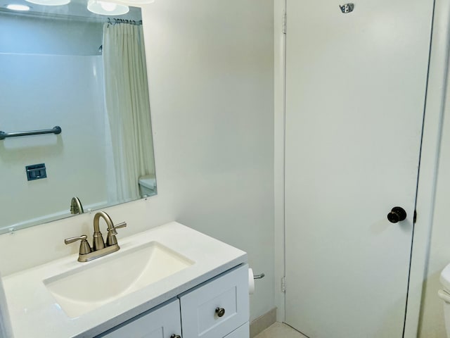 bathroom featuring walk in shower, vanity, and toilet