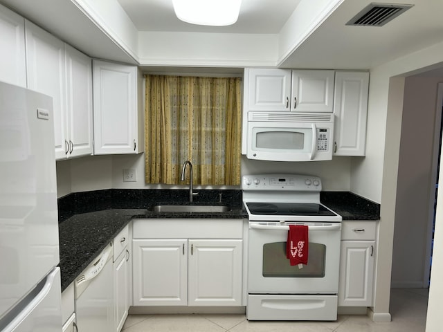 kitchen featuring white cabinets, white appliances, sink, and light tile patterned floors