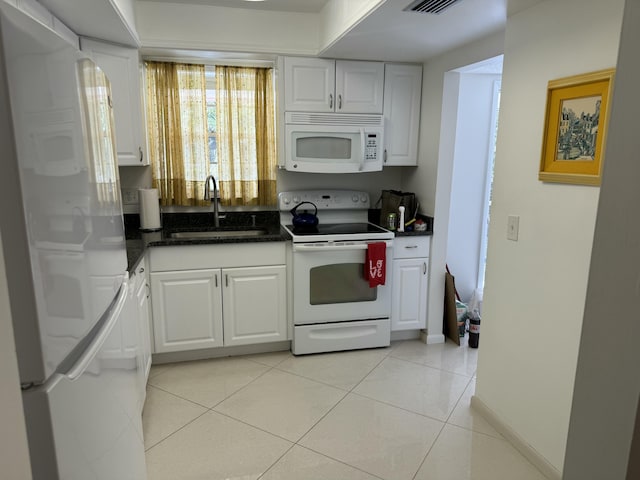 kitchen featuring sink, white cabinets, white appliances, and light tile patterned floors