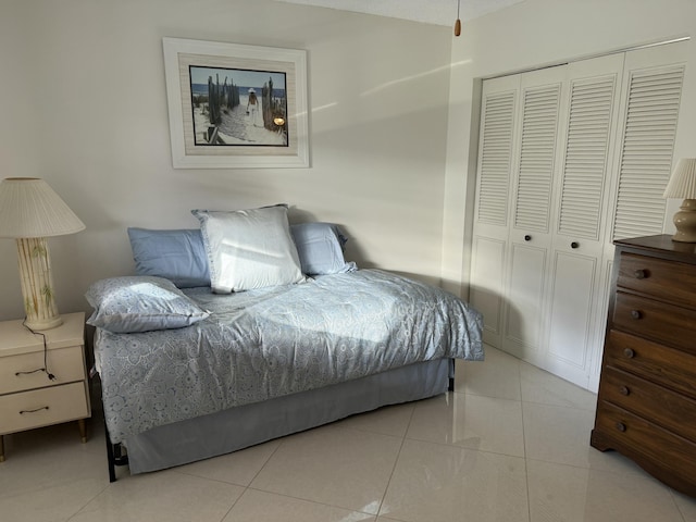 tiled bedroom featuring a closet