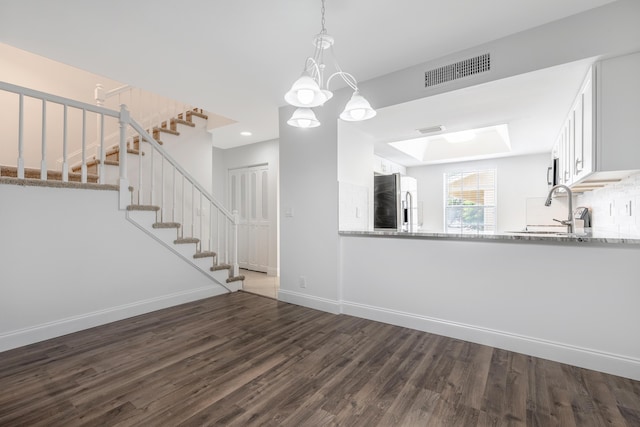 18520 SE Wood Haven Ln Unit I, Jupiter, FL 33469 - unfurnished living room featuring dark wood-type flooring, stairway, a sink, and baseboards
