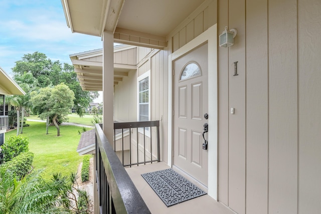 18520 SE Wood Haven Ln Unit I, Jupiter, FL 33469 - doorway to property with a lawn and board and batten siding