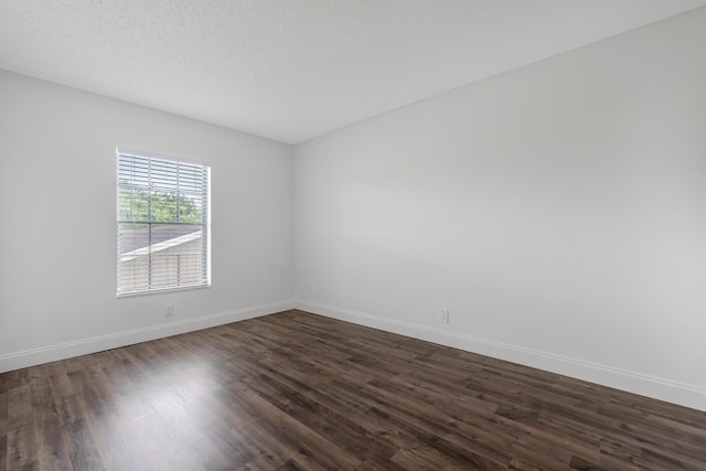 spare room featuring dark hardwood / wood-style flooring