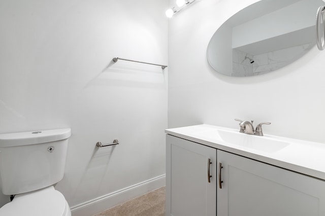 bathroom featuring tile patterned flooring, vanity, and toilet