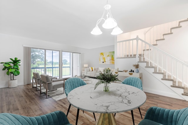 18520 SE Wood Haven Ln Unit I, Jupiter, FL 33469 - dining area with stairs, a water view, wood finished floors, and a chandelier