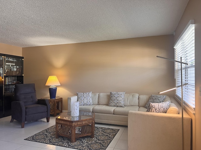 living room with light tile patterned flooring and a textured ceiling