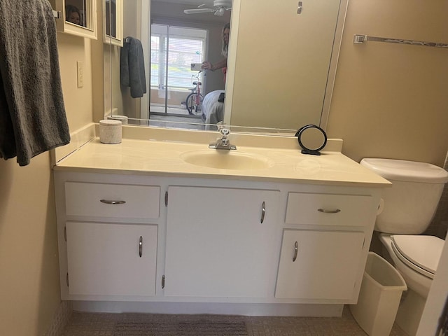 bathroom featuring vanity, ceiling fan, and toilet