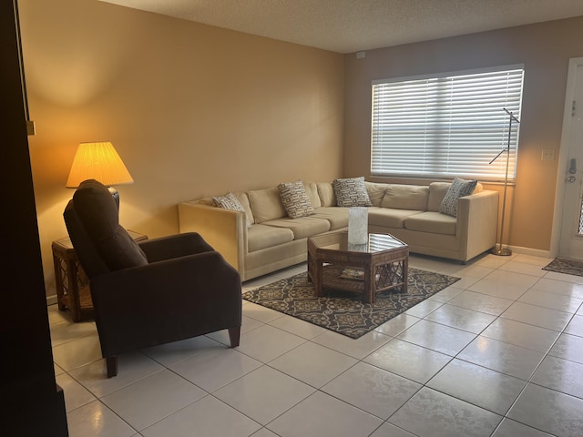 living room featuring light tile patterned floors and a textured ceiling