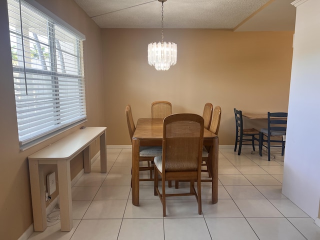 tiled dining area featuring a notable chandelier