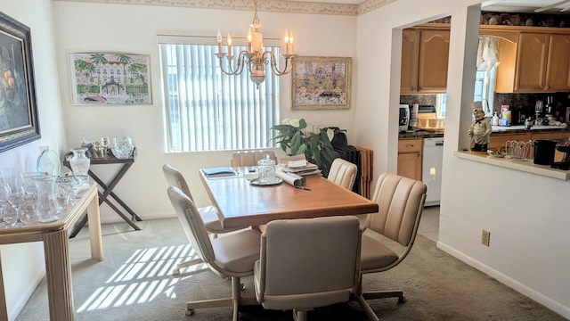 dining space featuring light colored carpet and a chandelier