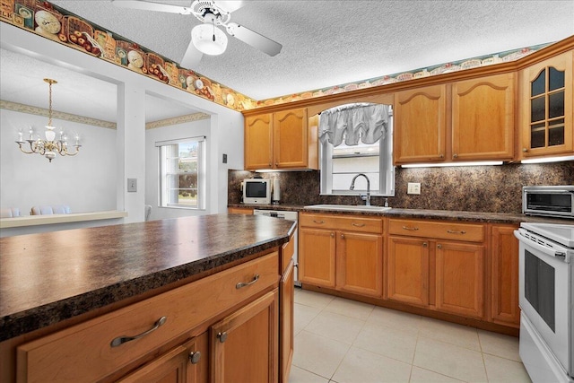 kitchen with electric range, dishwasher, dark countertops, glass insert cabinets, and a sink