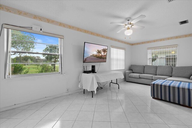 carpeted bedroom featuring a textured ceiling and ceiling fan